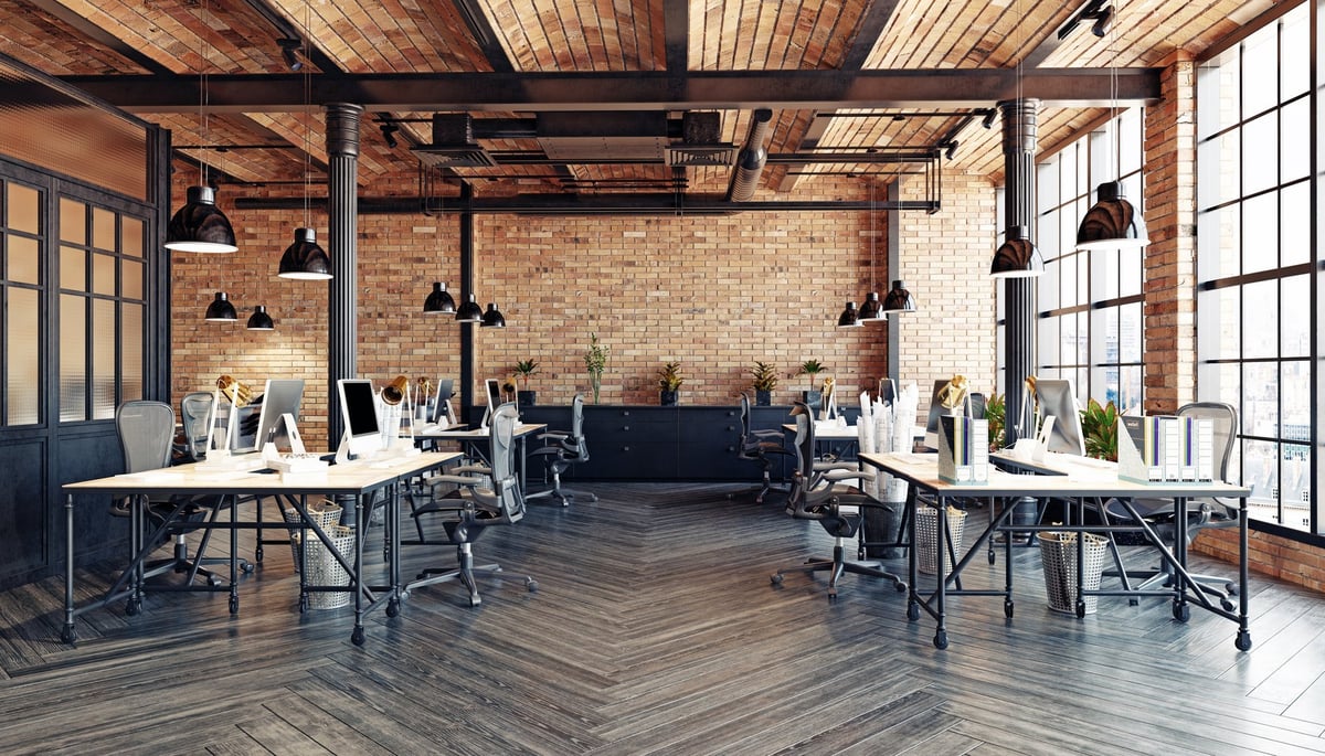 Industrial loft style KitaHub workspace interior with brick walls and wooden floors